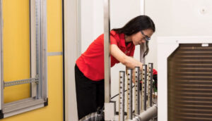 A person working in the HVAC Performance Carugate laboratory